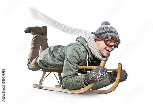 Happy adult man riding a sled for fun