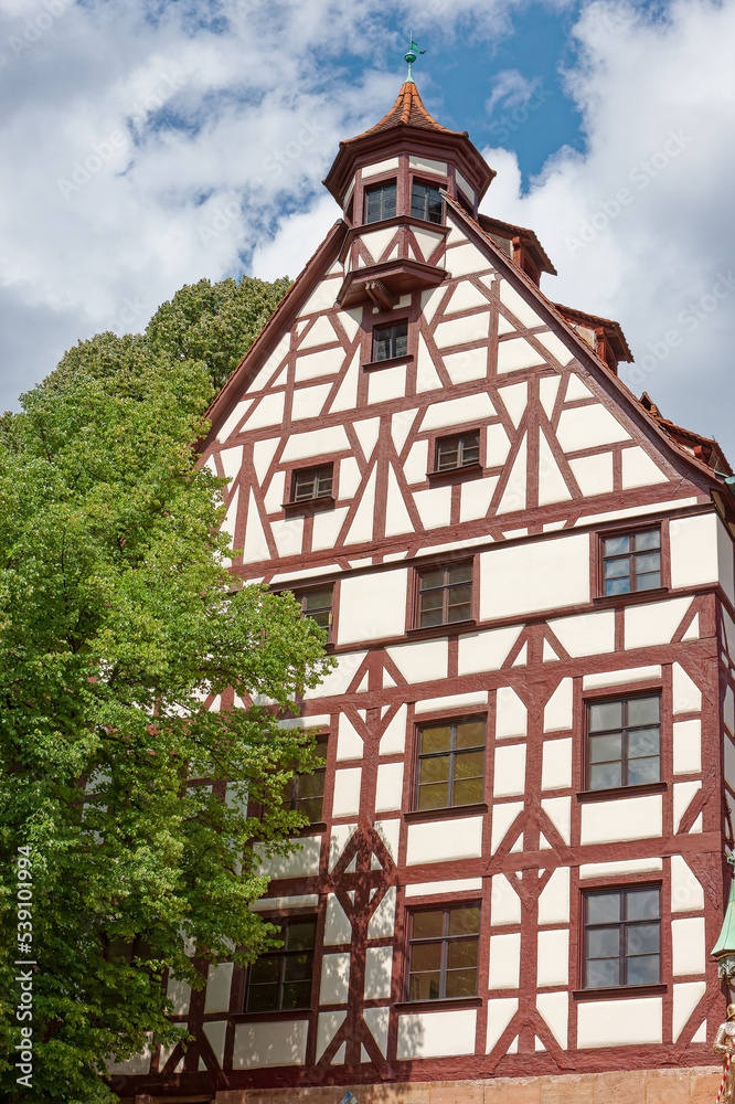 A half-timbered house with flowers on the windowsill. Republic of Bavaria, Germany A half-timbered house with flowers on the windowsill. Republic of Bavaria, Germany