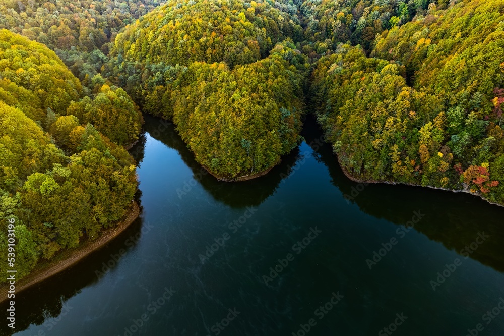 Colorful aerial view of Secu Lake in Caras-Severin - Romania, in the autumn, at sunrise. Scene captured from above, with a drone.