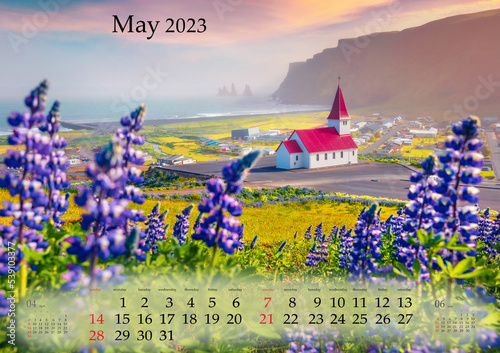 Horizontal wall calendar for 2023 year. May, B3 size. Set of calendars with amazing landscapes. Morning on Vikurkirkja church with Reynisdrangar cliff, Iceland. Monthly calendar ready for print.