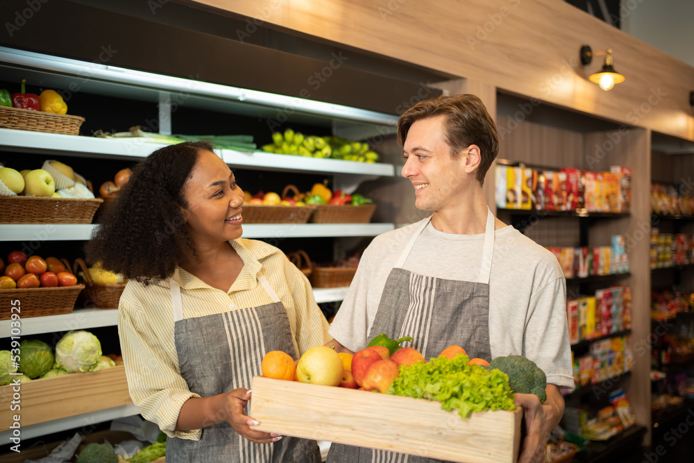 Portrait of a multi ethnic man and woman working in a supermarket or retail shop and food on grocery products. Food shopping. People lifestyle. Business service. A staff worker