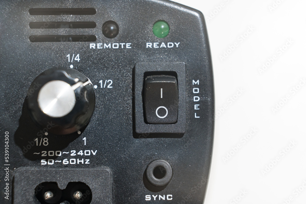 control buttons on the Studio flash on a white background. Compact flash designed for work in the studio and on the road for shooting portraits and photos on documents. control buttons on the Studio flash on a white background. Compact flash designed for work in the studio and on the road for shooting portraits and photos on documents.