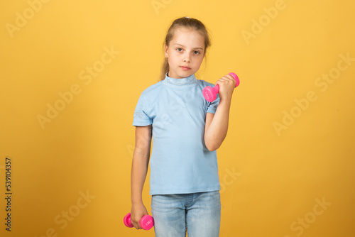 Fitness dumbbells kid exercise workout. Girl sporty child with dumbbells.
