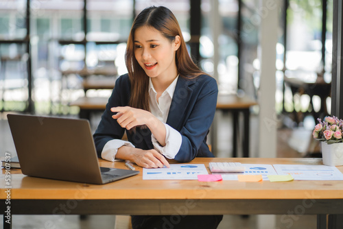 business woman or accountant who are using a calculator to calculate business data Accounting documents and laptop computer at the office business idea