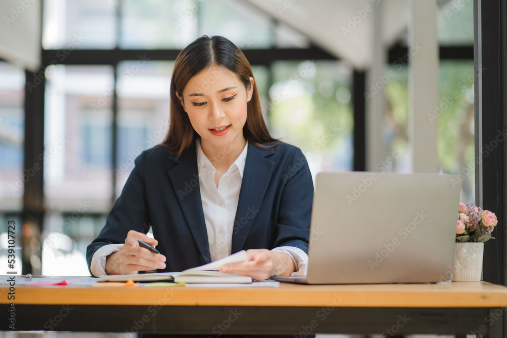 business woman or accountant who are using a calculator to calculate business data Accounting documents and laptop computer at the office business idea business woman or accountant who are using a calculator to calculate business data Accounting documents and laptop computer at the office business idea