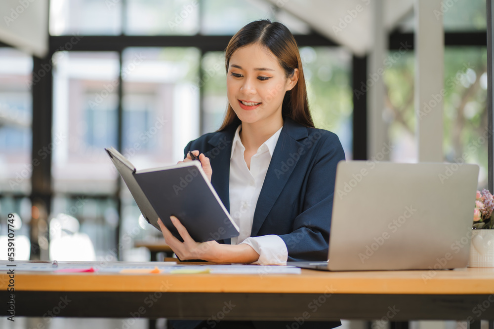 business woman or accountant who are using a calculator to calculate business data Accounting documents and laptop computer at the office business idea business woman or accountant who are using a calculator to calculate business data Accounting documents and laptop computer at the office business idea