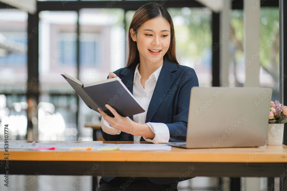 business woman or accountant who are using a calculator to calculate business data Accounting documents and laptop computer at the office business idea business woman or accountant who are using a calculator to calculate business data Accounting documents and laptop computer at the office business idea