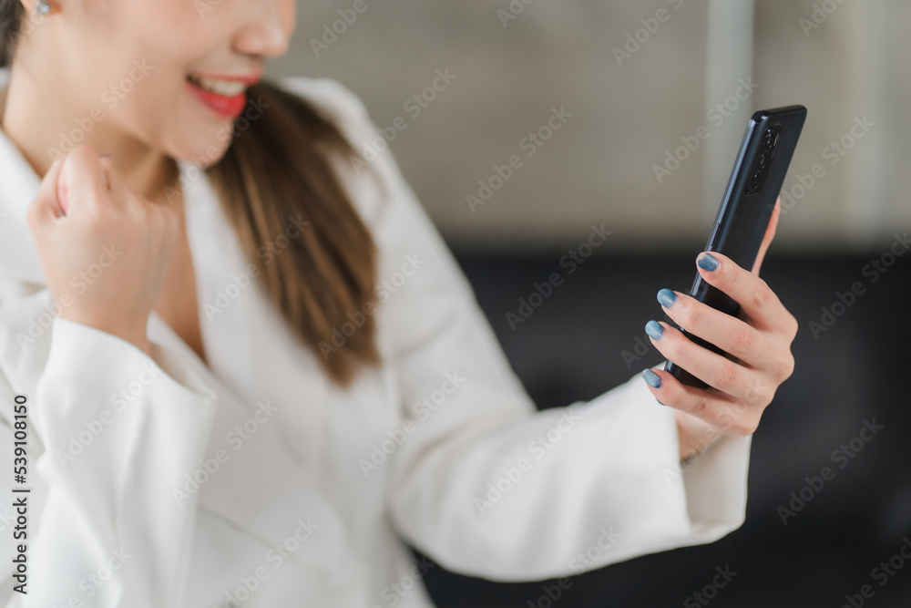Happy young asian businesswoman sitting on her workplace in the office. Young woman working at laptop in the office Happy young asian businesswoman sitting on her workplace in the office. Young woman working at laptop in the office