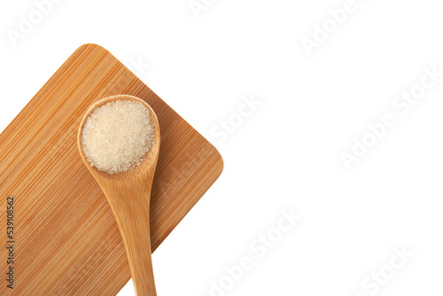 Gelatin or gelatine powder, translucent, flavorless food ingredient, derived from collagen. Food additive E441 in wooden spoon on chopping board, top view, copy space photo