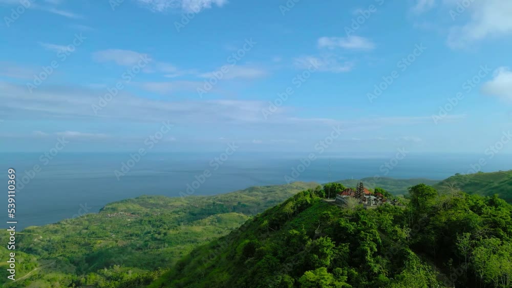 Tunjuk Pusuh Temple with amazing landscape with green hills and clouds and sky, Nusa Penida Island, Bali, Aerial Shot Indonesia Tunjuk Pusuh Temple with amazing landscape with green hills and clouds and sky, Nusa Penida Island, Bali, Aerial Shot Indonesia