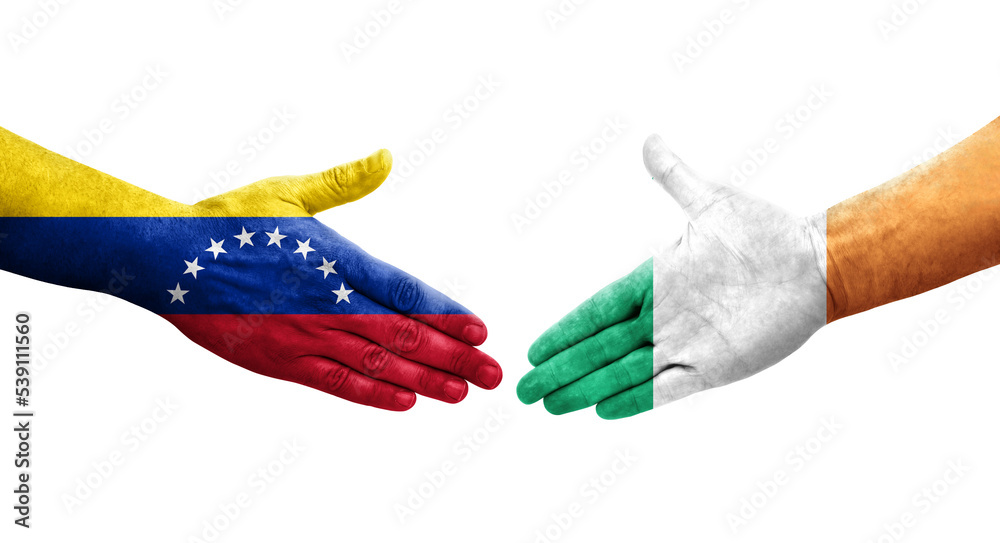Handshake between Ireland and Venezuela flags painted on hands, isolated transparent image. Handshake between Ireland and Venezuela flags painted on hands, isolated transparent image.