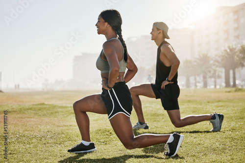 Fitness couple, outdoor lunge exercise and training workout on grass field in urban city. Happy woman, healthy man and people friends leg stretching body in wellness, summer challenge and motivation