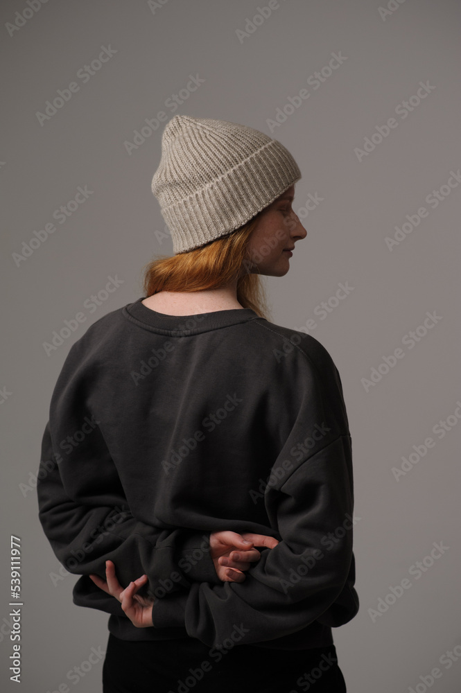 young girl model in beige hipster hat and coat isolated on light background. Product photo mockup for fashion brands and marketplaces, woolen cap, turkish textiles.