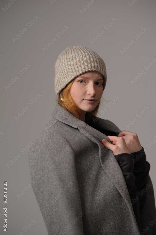 young girl model in beige hipster hat and coat isolated on light background. Product photo mockup for fashion brands and marketplaces, woolen cap, turkish textiles. young girl model in beige hipster hat and coat isolated on light background. Product photo mockup for fashion brands and marketplaces, woolen cap, turkish textiles.