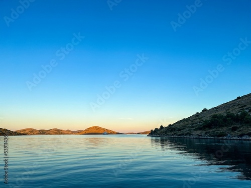 Scenic sunset over the lake with a gradient clear sky - great for wallpapers photo