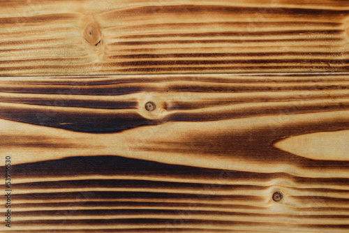 Opalane świerkowe deski z widocznym poziomym wzorem słojów drewna photo