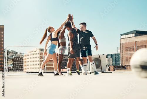 Teamwork, football and high five with people and sports training for goals, success and winner after exercise. Health, wellness and soccer player celebration with friends in fitness support together