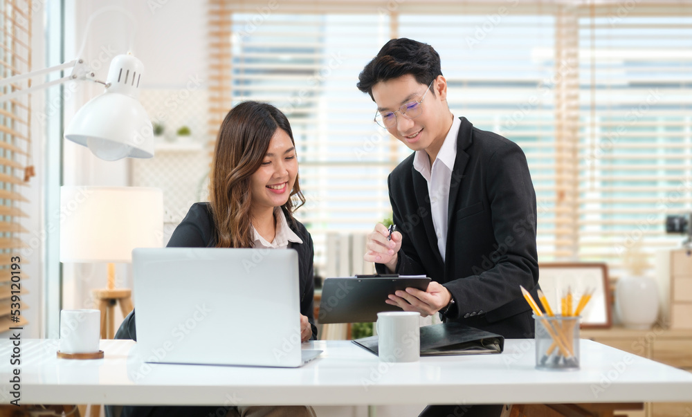 Smiling businessman negotiating about business project with female coworker. Smiling businessman negotiating about business project with female coworker.