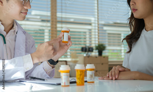 Cropped shot of doctor giving advice, explaining medicine dosage to a female patient.