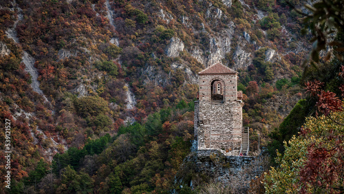 The medieval Asenova fortress and the Church of the Holy Virgin Petrichka in Bulgaria in autumn photo