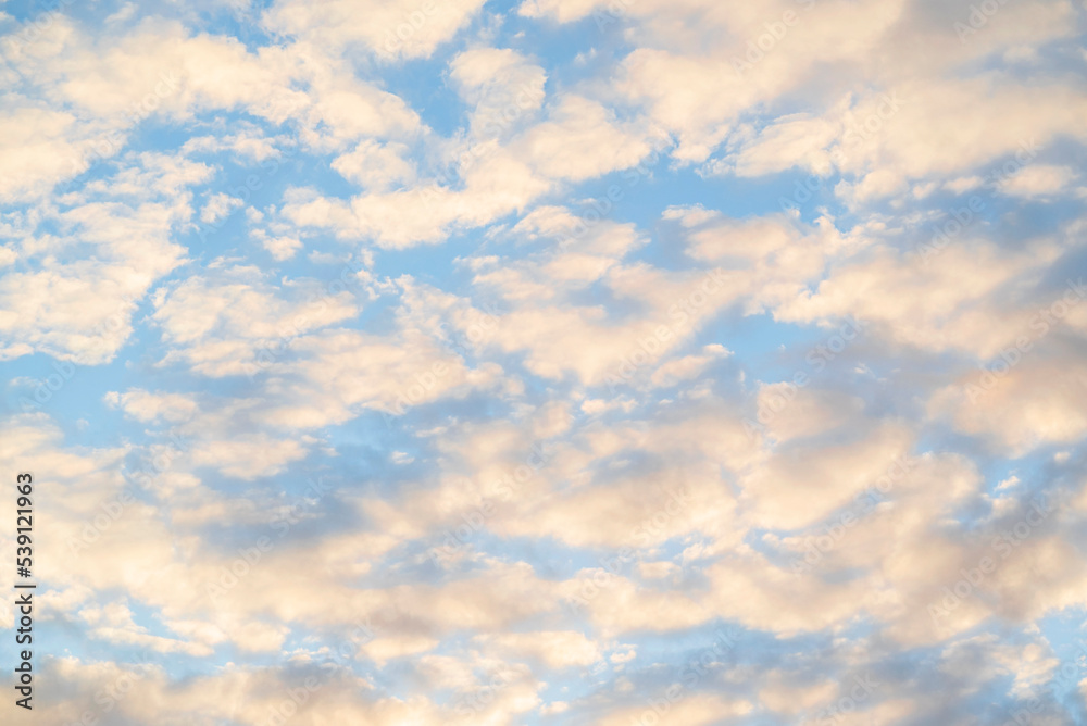 Fototapeta premium Beautiful blue cloudy shining sky in the evening
