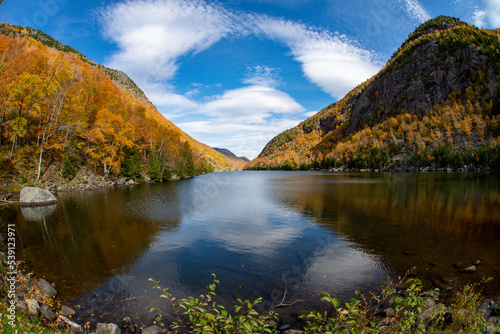 Fototapeta Naklejka Na Ścianę i Meble -   Fall colors in the Adirondacks with reflection in the water