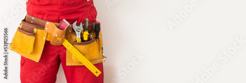 man and tools in leathern belt photo