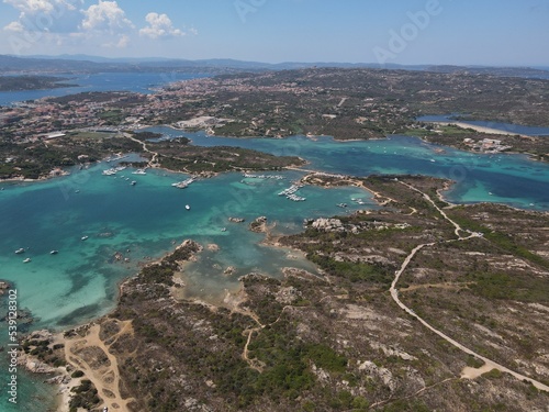 Aerial view of La Maddalena Island, Isola Giardinelli with the drone view of Caprera Island in Sardegna, Italy. Birds eye view of crystalline and turquoise water in north Sardinia, luxury yacht, boat.