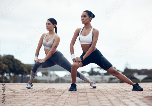Fitness, woman and friends stretching for workout, exercise and training for healthy lifestyle in the outdoors. Active women in urban sports stretch for performance, health and cardio warm up routine