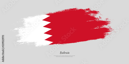 Happy Independence Day of Bahrain. National flag on artistic stain brush stroke background.