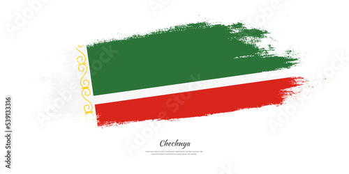 Happy Independence Day of Chechnya. National flag on artistic stain brush stroke background.