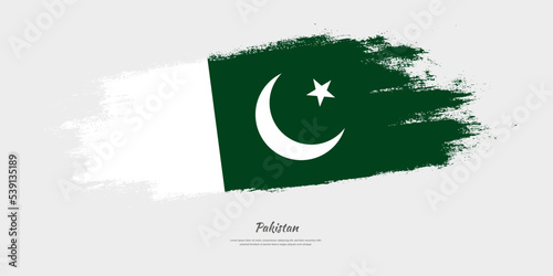 Happy Independence Day of Pakistan. National flag on artistic stain brush stroke background.