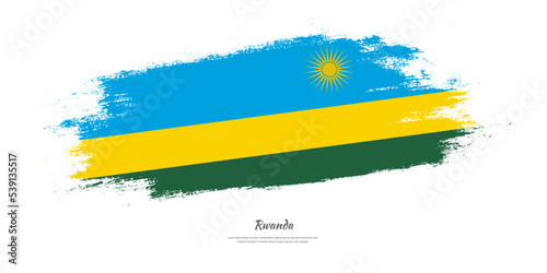 Happy Independence Day of Rwanda. National flag on artistic stain brush stroke background.
