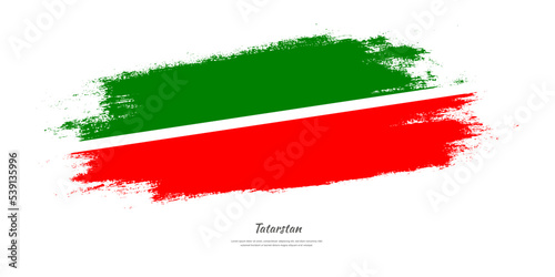 Happy Independence Day of Tatarstan. National flag on artistic stain brush stroke background.