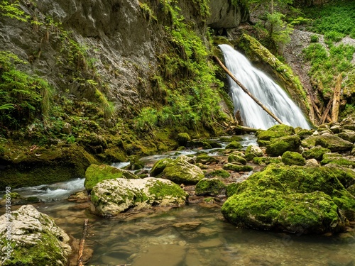 Beautiful landscape of the Fan waterfall with moss covered stones in Galbena Gorges, Romania photo