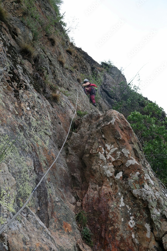 Hiking and via ferrata next to the village of Les Deux Alps, in the french Alps. There is some walking through the forest where you see structures of the old mining activities.