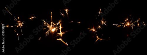 Set of festive sparkler with sparks on black background for overlay blending mode for holiday design projects. photo