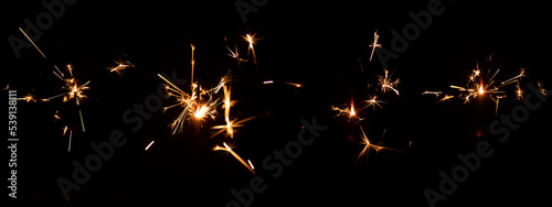 Set of festive sparkler with sparks on black background for overlay blending mode for holiday design projects.