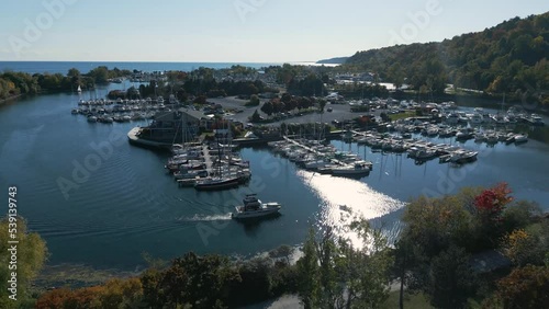 Drone shot of a park that looks like an island with boats near a forest on a clear sunny day. At bluffers Park and Beach in Ontario Canada. photo