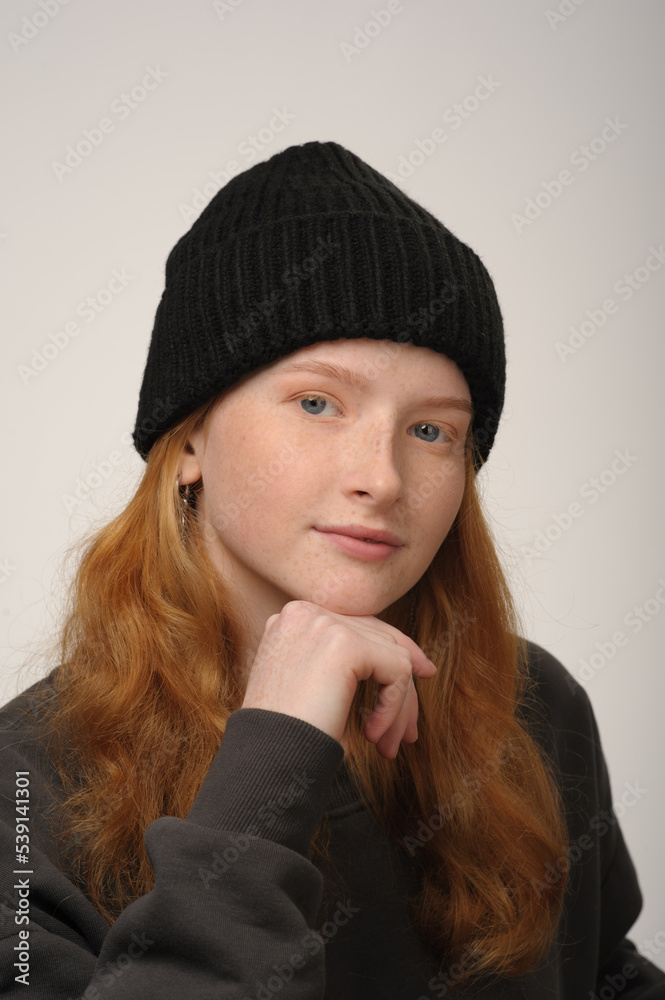 young girl model in black cap and grey jackett isolated on grey background. Product photo mockup for fashion brands and marketplaces. young girl model in black cap and grey jackett isolated on grey background. Product photo mockup for fashion brands and marketplaces.