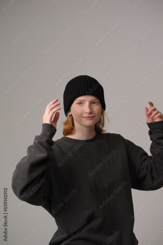young girl model in black cap and coat isolated on grey background. Product photo mockup for fashion brands and marketplaces. young girl model in black cap and coat isolated on grey background. Product photo mockup for fashion brands and marketplaces.