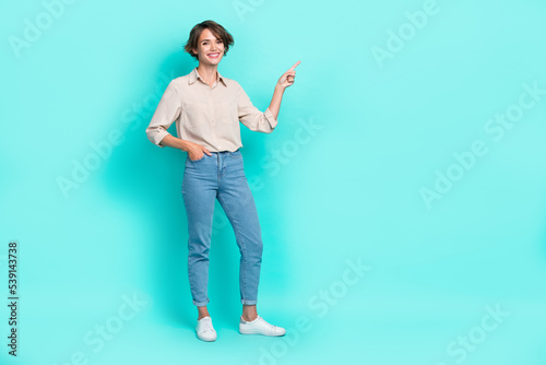 Full length photo of cheerful satisfied girl arm index present empty space recommend delivery service isolated on cyan color background