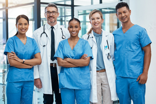 Happy doctors and nurse smile at a hospital with support, teamwork and collaboration with diversity. Team of expert medical professionals smiling at work together at clinic in the healthcare industry photo