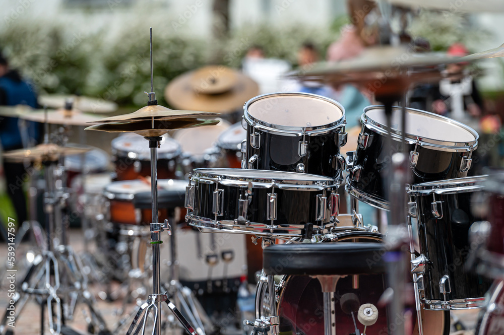 A set of plates in a drum set. At a concert of percussion music, selective focus, closeup