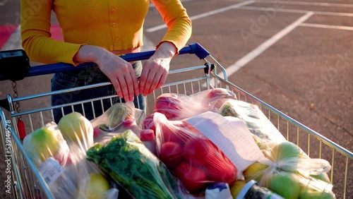 Food cart closeup. Trolley full of goods goes to a supermarket 