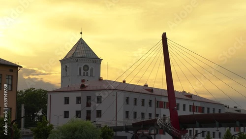 Sunset sky time lapse and people walking on Mitava bridge - pedestrian and cyclist bridge in Jelgava across the Driksa river photo