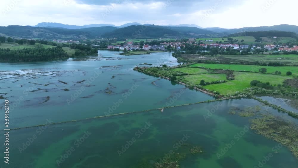 Aerial view from a drone of the marsh in the surroundings of Molino de Cerroja in the town of Escalante. Natural Park of the Marshes of Santoña, Victoria, Noja and Joyel. Cantabrian Sea. Cantabria. Sp Aerial view from a drone of the marsh in the surroundings of Molino de Cerroja in the town of Escalante. Natural Park of the Marshes of Santoña, Victoria, Noja and Joyel. Cantabrian Sea. Cantabria. Sp