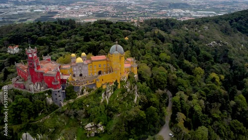 Beautiful Pena Palace situated on the top of a hill in the Sintra Mountains above the town of Sintra. The palace is UNESCO World Heritage Site and one of the Seven Wonders of Portugal. Drone right photo