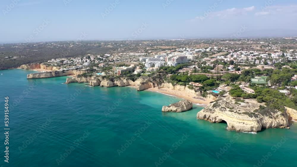 Drone point of view of beautiful Portuguese city Carvoeiro. Situated in Lagoa, Algarve, South of Portugal, is a travel destination. Typically, Portuguese landscape. Drone ascending and tilt down Drone point of view of beautiful Portuguese city Carvoeiro. Situated in Lagoa, Algarve, South of Portugal, is a travel destination. Typically, Portuguese landscape. Drone ascending and tilt down