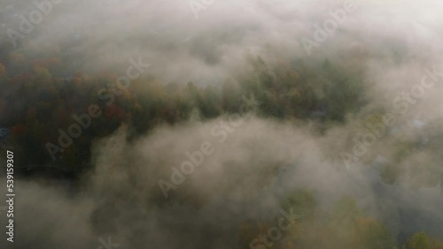 Thick Clouds Over Dense Forest And River In Autumn In Sherbrooke, Quebec, Canada. aerial photo